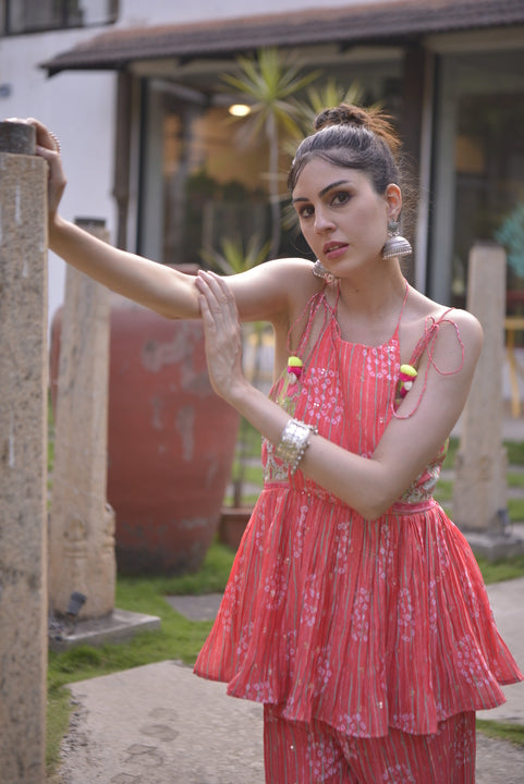 orange sleeveless kurta palazzo set with tassel straps and wide-leg pants
